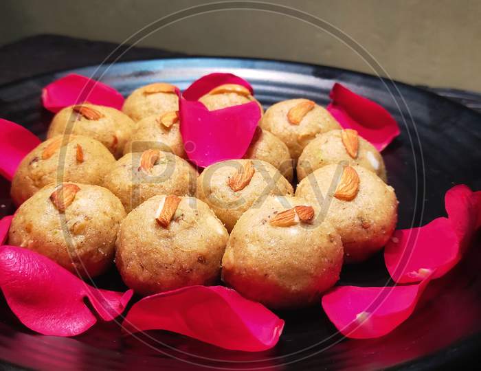 Pinni a Punjabi sweet dessert (ladoo) garnished with rose petals.