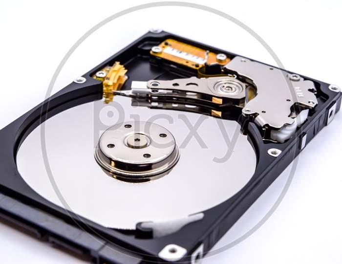 Internal parts of a hard disk isolated on a white background. Close up of Hard disk drive inside view.