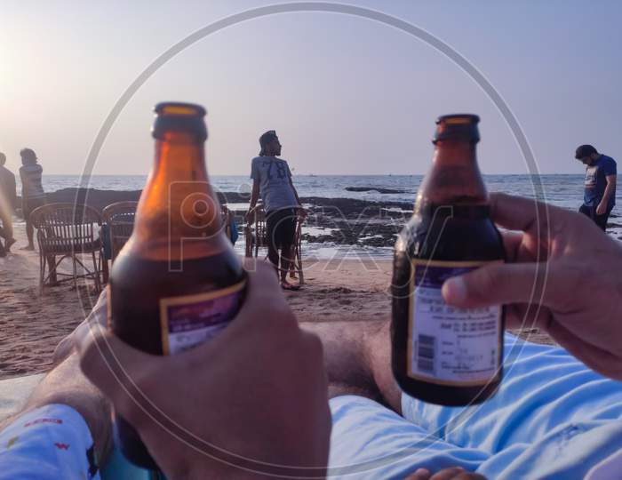 Anjuna - india / Goa - December 2019: Relaxing with beer in Anjuna beach Goa with during sunset