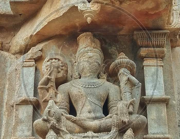 A 12th century Indian God Broken sculpture in a Temple at Udaipur