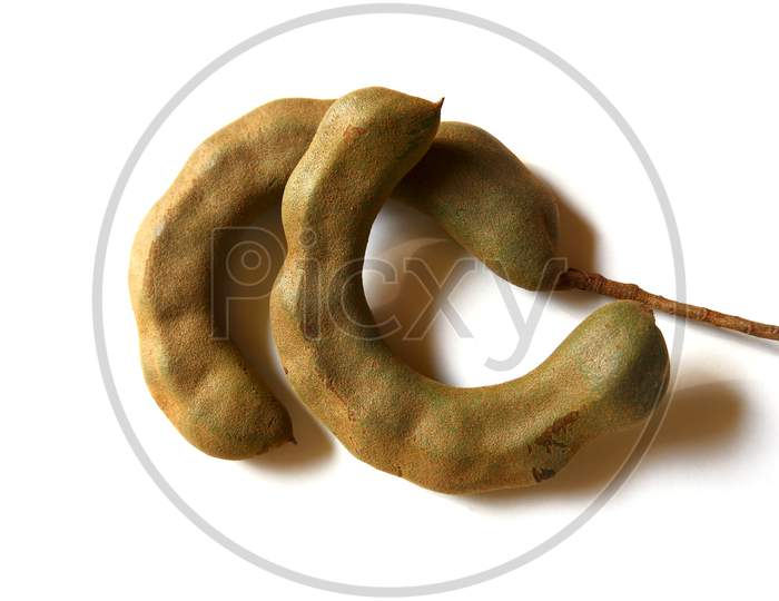 Top Shot Of Fresh Tamarind Nuts Isolated On White Surface