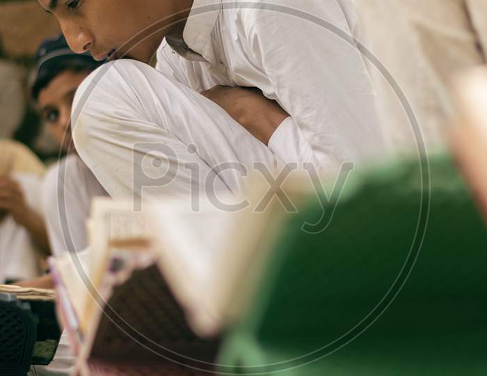 Young boys reading Quran (muslim holy book) at madrassa