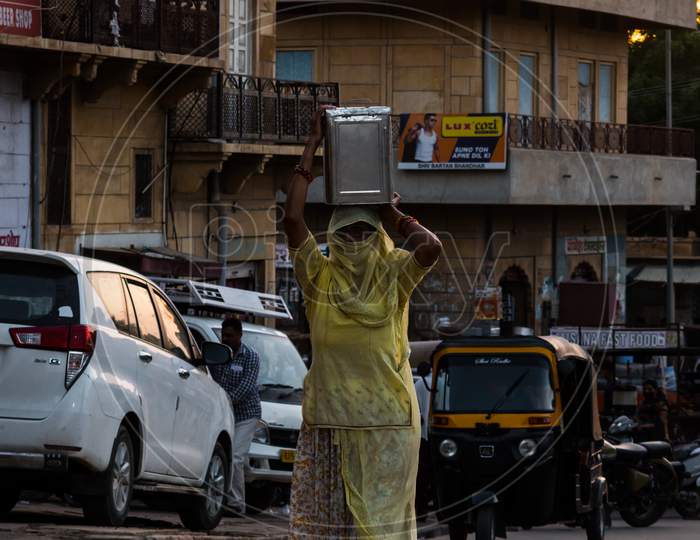 Woman Carrying Crate On Her Head