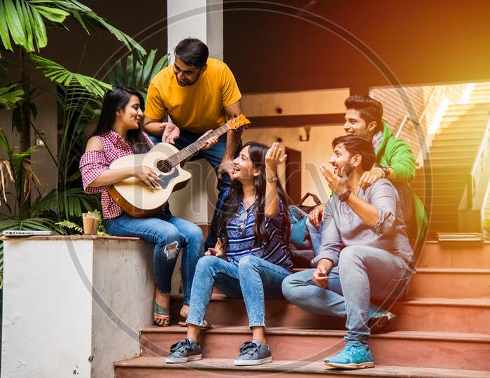 Indian Asian University Students Singing Song With Guitar, In College Campus
