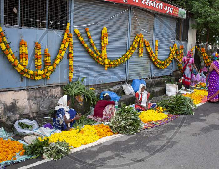 Women Selling Marigold Flowers And Garlands On The Street