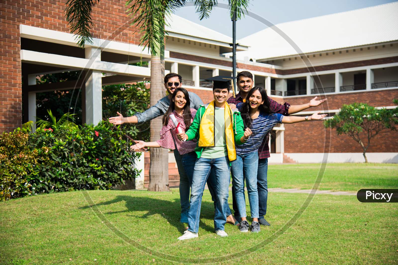Indian Asian Group Of College Students Celebrating Success After Convocation Ceremony In Campus