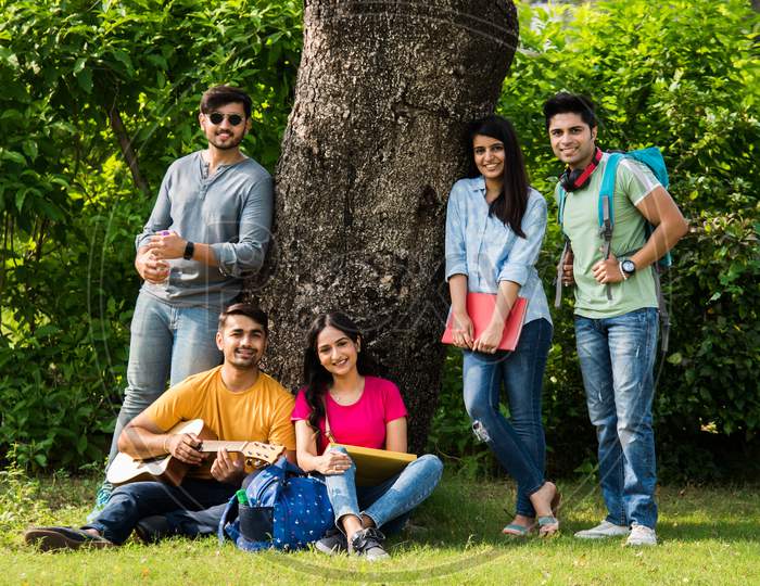 Indian Asian University Students Singing Song With Guitar, In College Campus