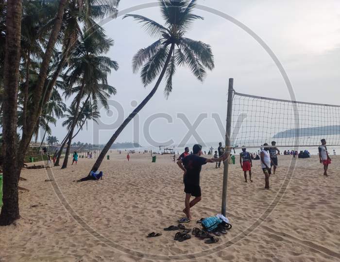 Goa - india - December 2019:  People playing volleyball in baina beach