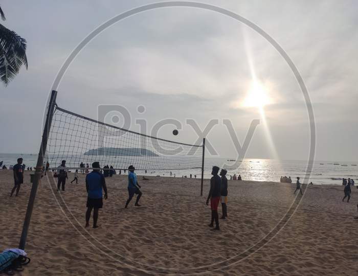 Goa - india - December 2019:  People playing volleyball in baina beach