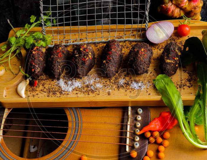 Perilla seed and spicy salad on top of a guitar.