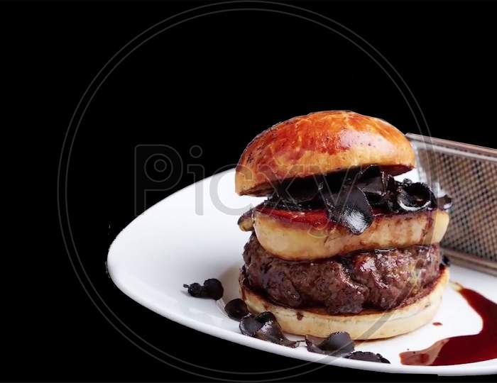 beef meat expensive burger with cheese and green salad on a black background