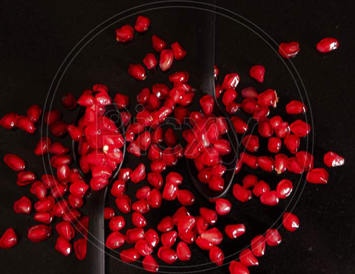 Pomegranate Seeds In Two Spoons