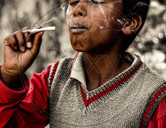 Boy trying a paper smoke.