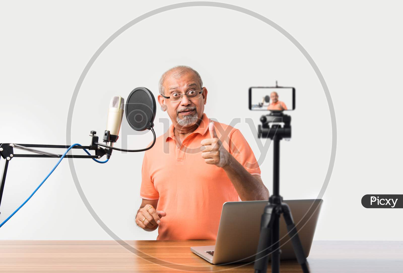 Indian Asian Old Man Video Blogger Speaking In Microphone While Recording A Video In Smartphone