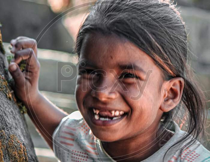 A girl smiling while taking her photo