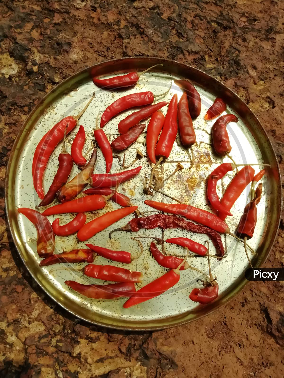 Closeup Of Red Chili Peppers In A Plate Isolated On A Surface