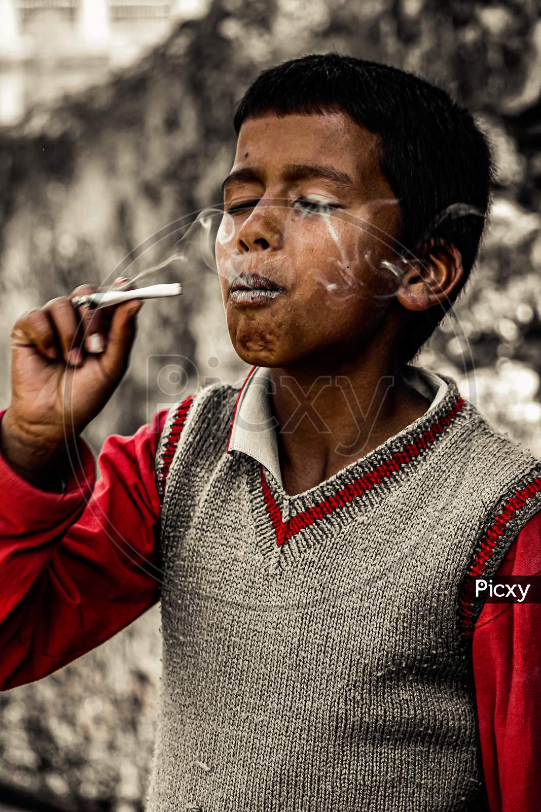 Boy trying a paper smoke.