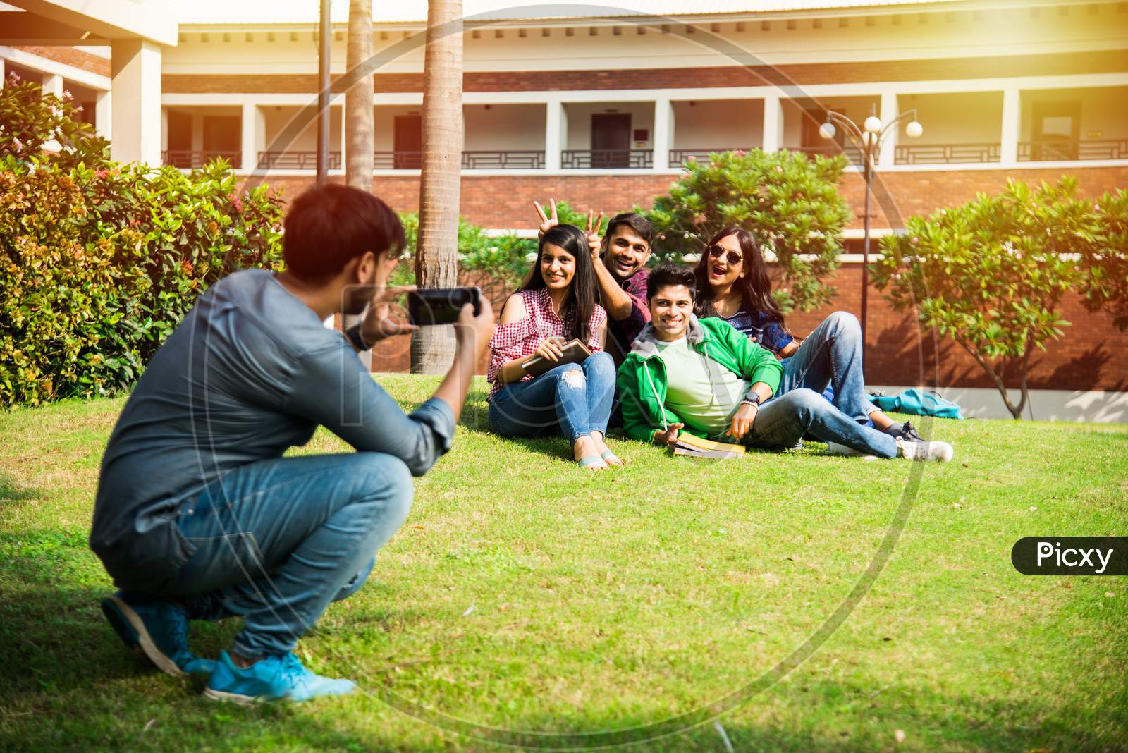 Asian Indian Cheerful College Students In Group Taking Selfie Picture In Smartphone