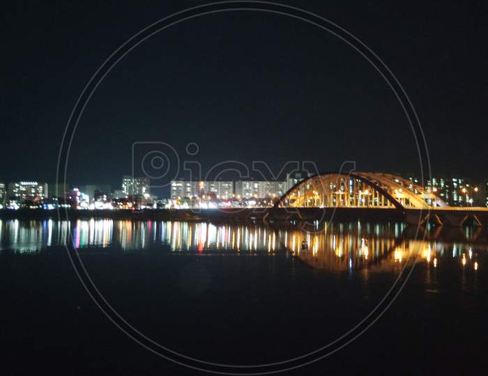 Night View Of A Beautiful Scene Of Bridge Over Sea Water In The Evening Time.