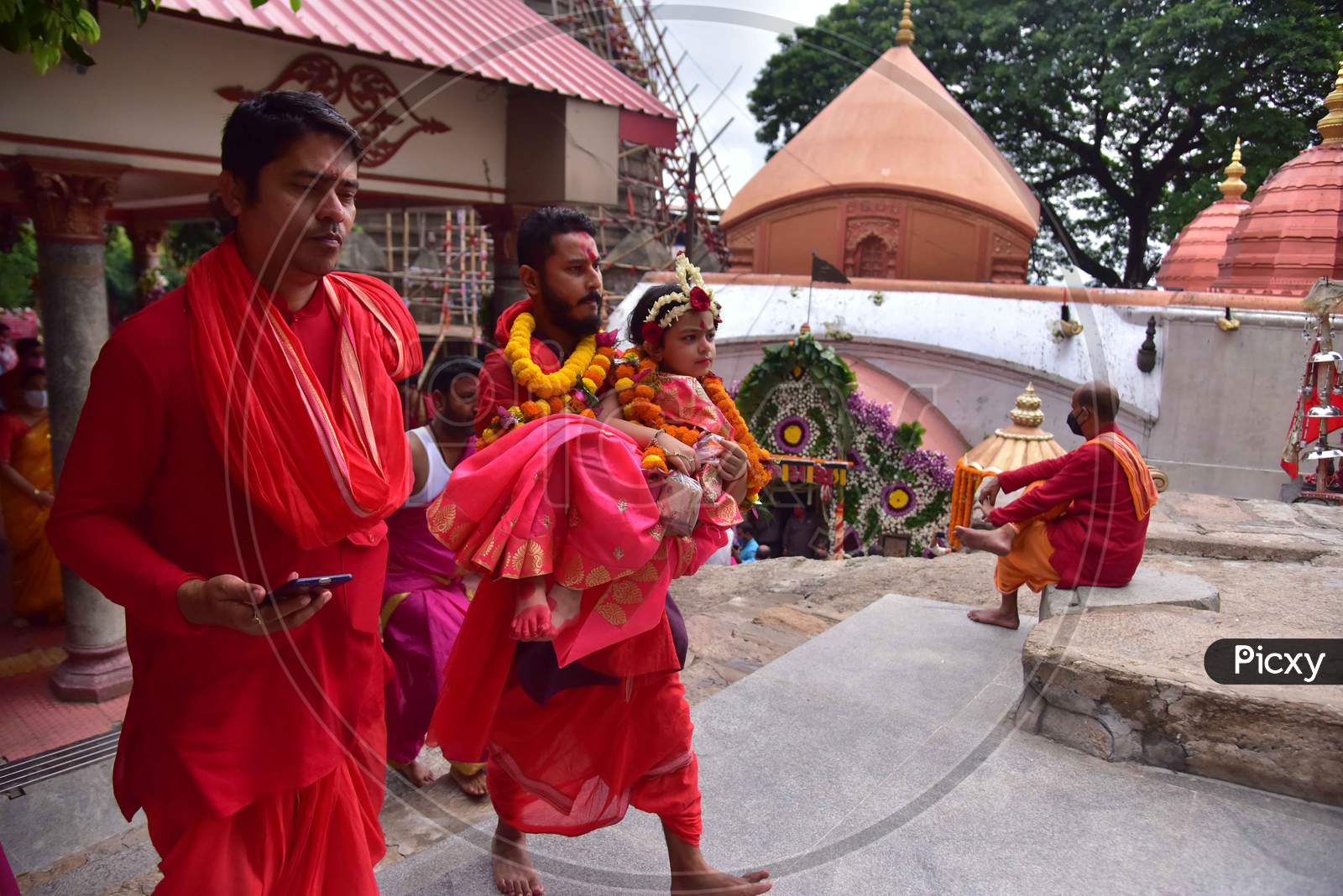Hindu devotees carry girls dressed as the Hindu goddess Durga for the "Kumari" puja rituals during the Durga Puja festival at the Kamakhya Temple in Guwahati on oct 25,2020.