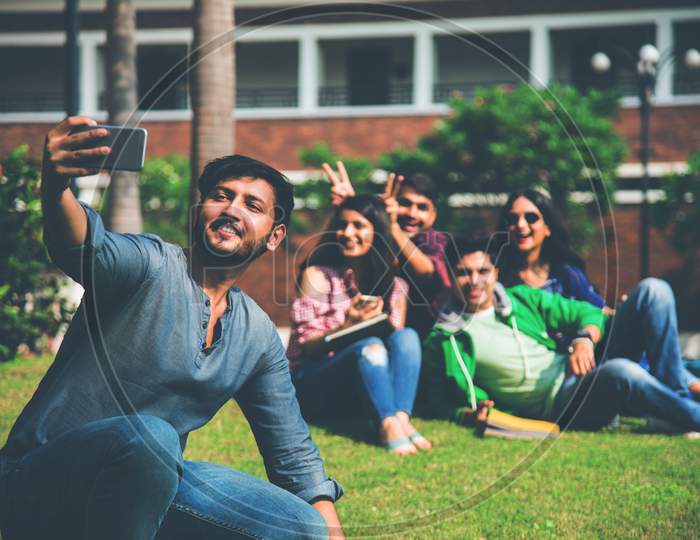 Asian Indian Cheerful College Students In Group Taking Selfie Picture In Smartphone