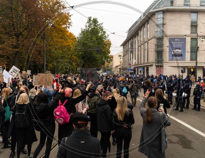Krakow, Poland - October 25, 2020: Polish People Gathered Together Wearing Mask During Pandemic In Order To Protest Against A Legislative Proposal For A Total Ban Of Abortion In The Main City Center