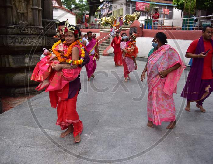 Hindu devotees carry girls dressed as the Hindu goddess Durga for the "Kumari" puja rituals during the Durga Puja festival at the Kamakhya Temple in Guwahati, on oct 25,2020