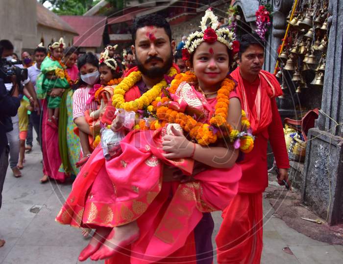 Hindu devotees carry girls dressed as the Hindu goddess Durga for the "Kumari" puja rituals during the Durga Puja festival at the Kamakhya Temple in Guwahati on oct 25,2020.