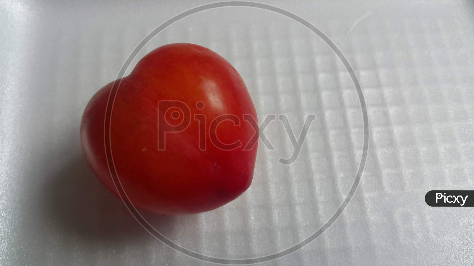 Closeup View Of Red Plum On A White Grey Background