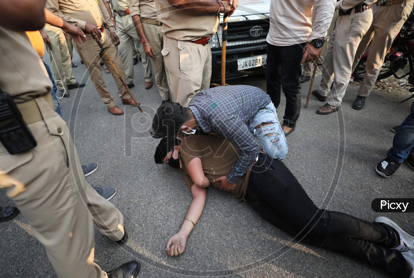 Police attempt to detain ABVP activists trying to hoist the Tricolor at PDP headquarters, in Jammu,, Oct. 25, 2020.