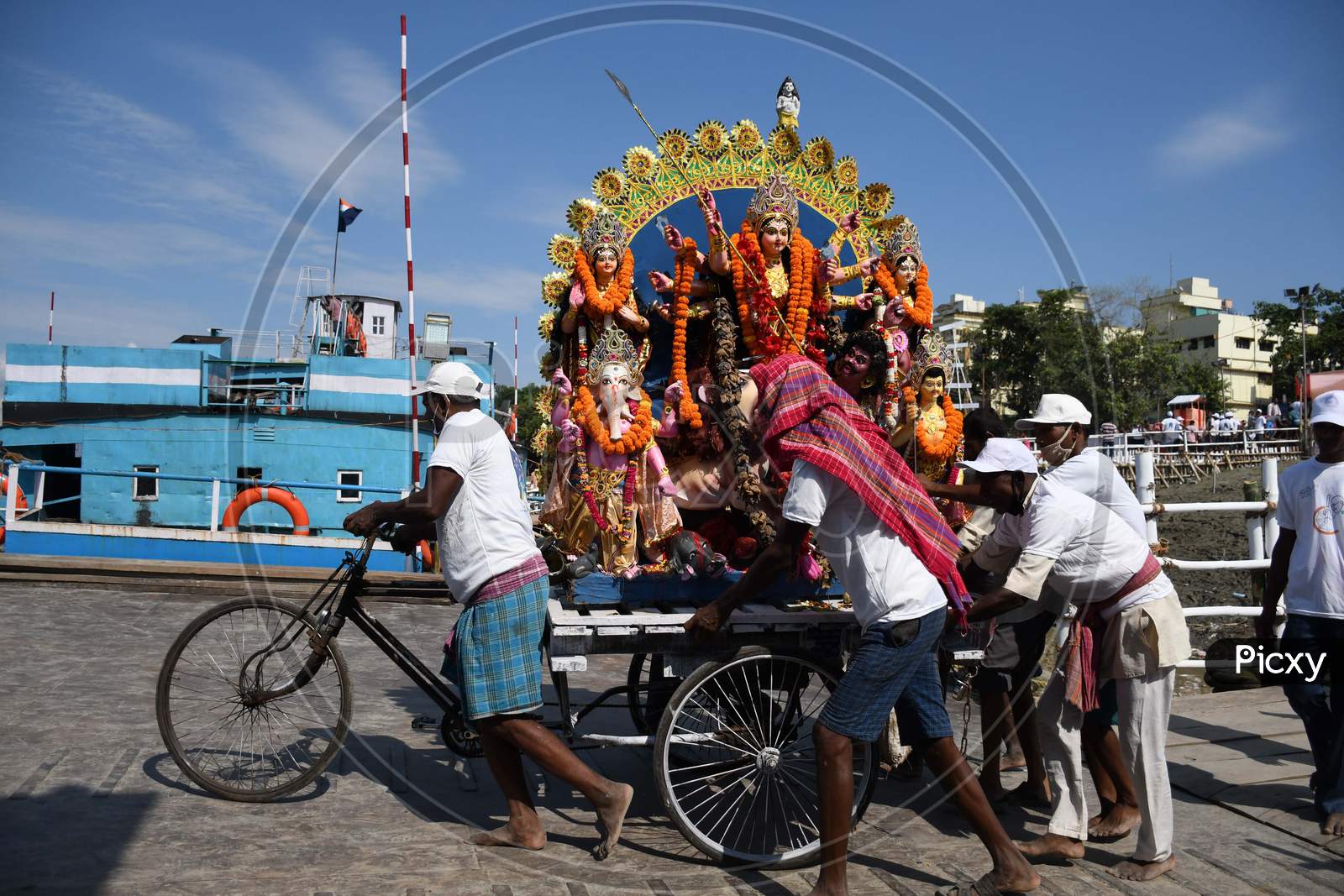 Municipal workers carry an idol of the Hindu goddess Durga for immersion in the waters of the river Brahmaputra on the last day of the Durga Puja festival in Guwahati on oct 26,2020.