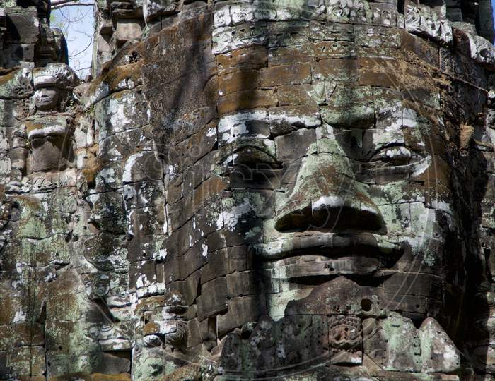 Smiling Stone Face At East Gate Of Bayon Temple In Cambodia