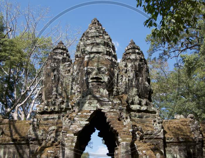 Stone Faces At East Gate Of Bayon Temple In Cambodia