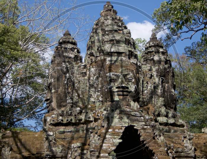 Stone Faces At East Gate Of Bayon Temple In Cambodia