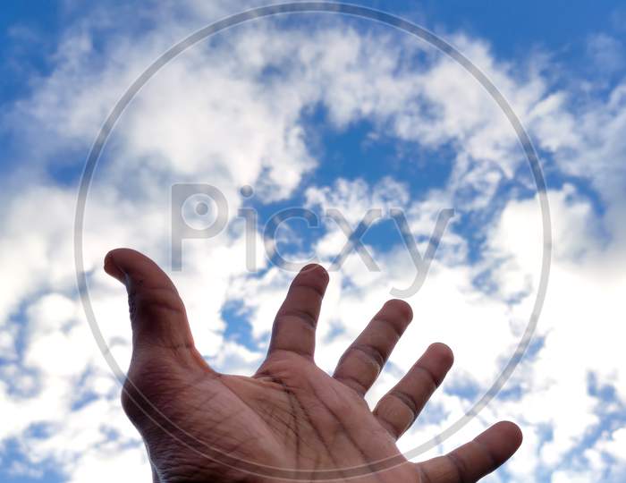 Hand towards sky