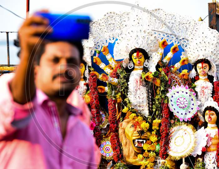 A man takes selfie with the Idol of Goddess Durga on the last day of Navratri in Hyderabad on October 26, 2020.