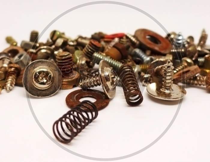 Collection of different size nuts, bolts, screws and springs isolated on white background
