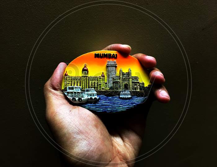 Drawing of Mumbai city on a surface holding in hand