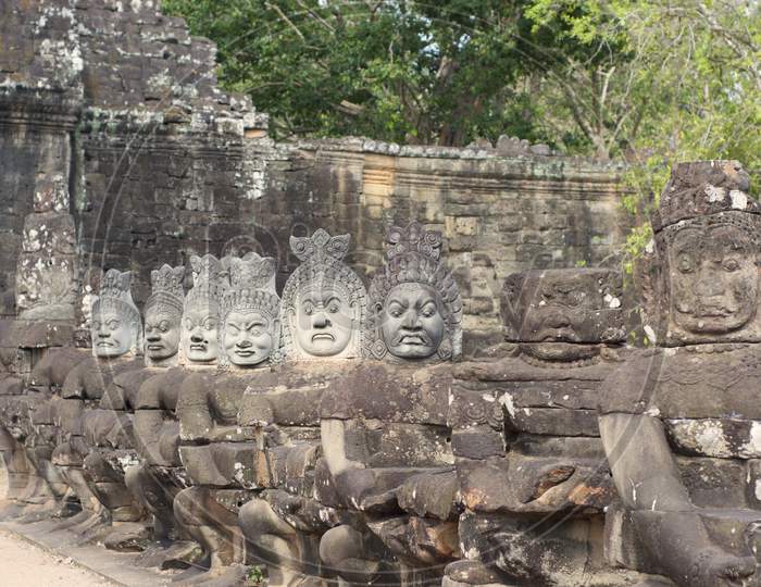 Asuras (Demons) Statues In A Row At The Bayon Temple Entrance Gate