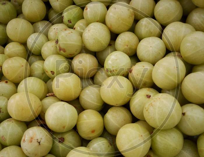 A bunch of fresh Amla fruit on local market . Indian Gooseberry for sale