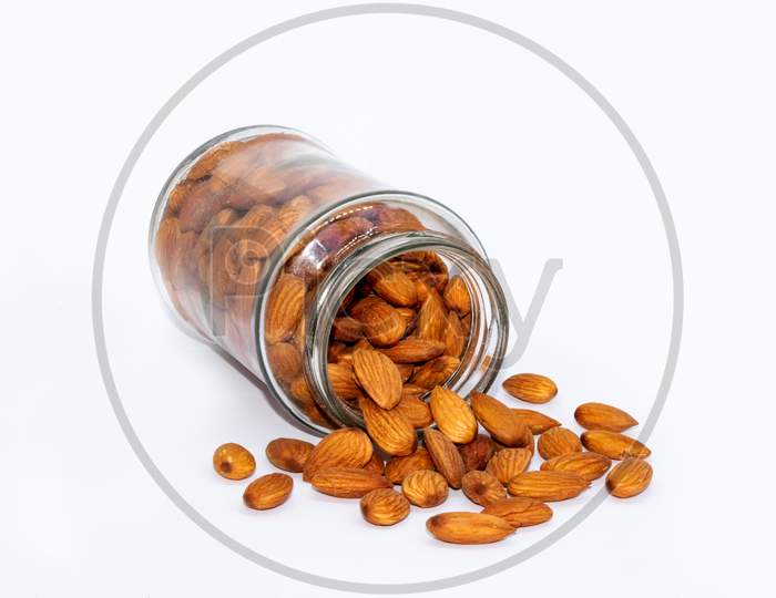 Almond nuts scatters from glass jar