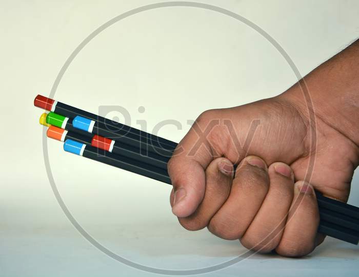 Hand holding pencils image