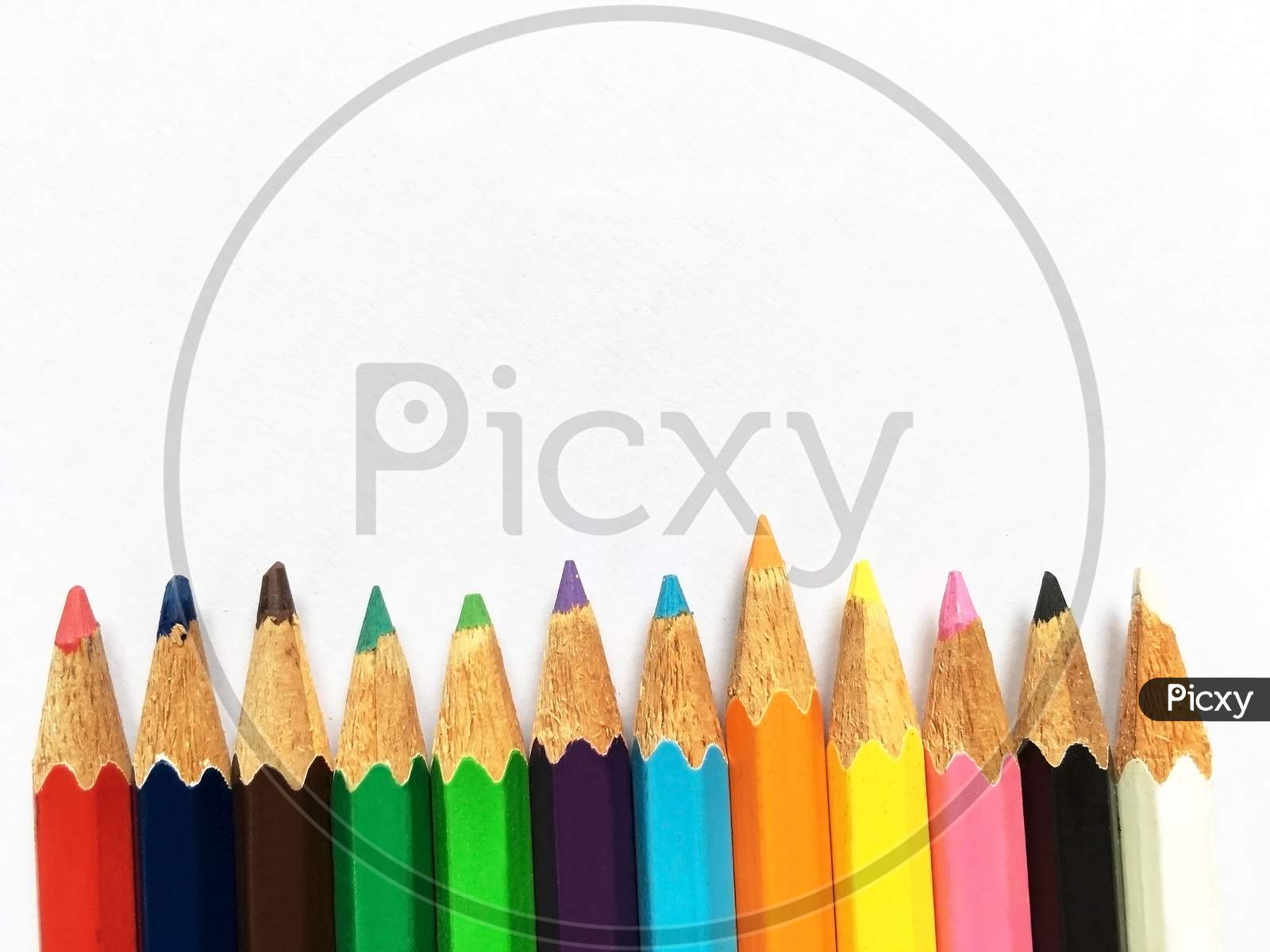 Row stacking colorful pencils isolated on white background