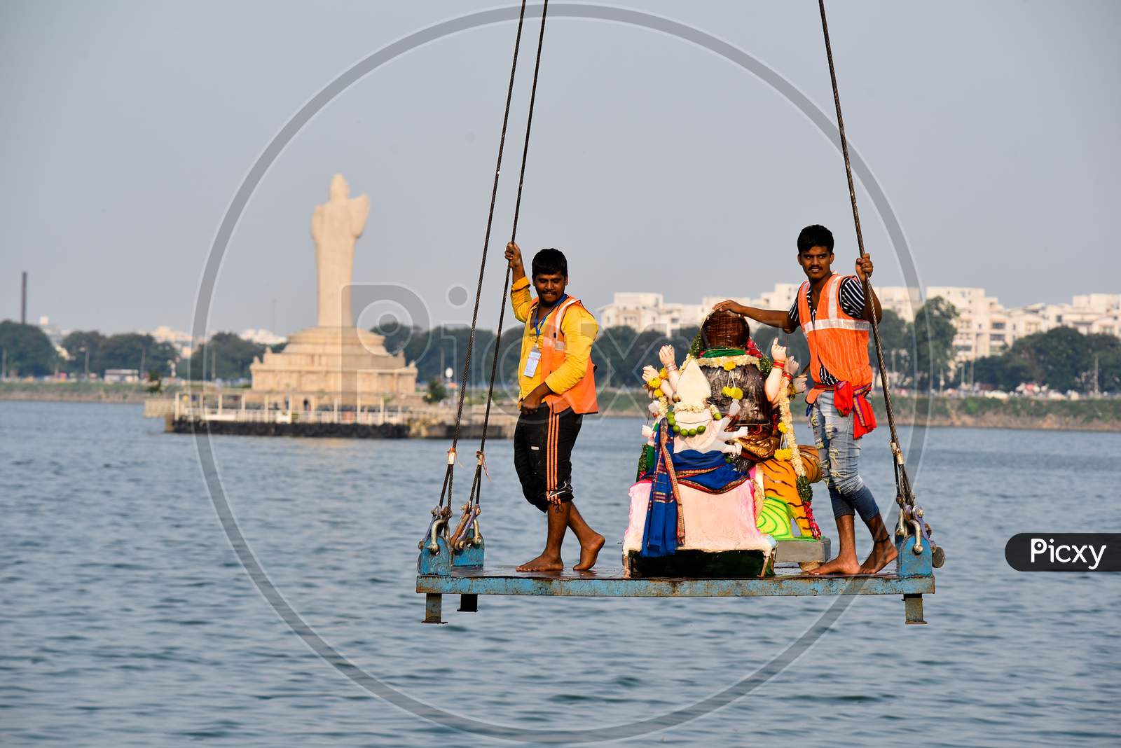 GHMC workers take Idol of Goddess Durga in a Crane for Immersion in Hussain Sagar on the last day of Navratri in Hyderabad, October 26, 2020.