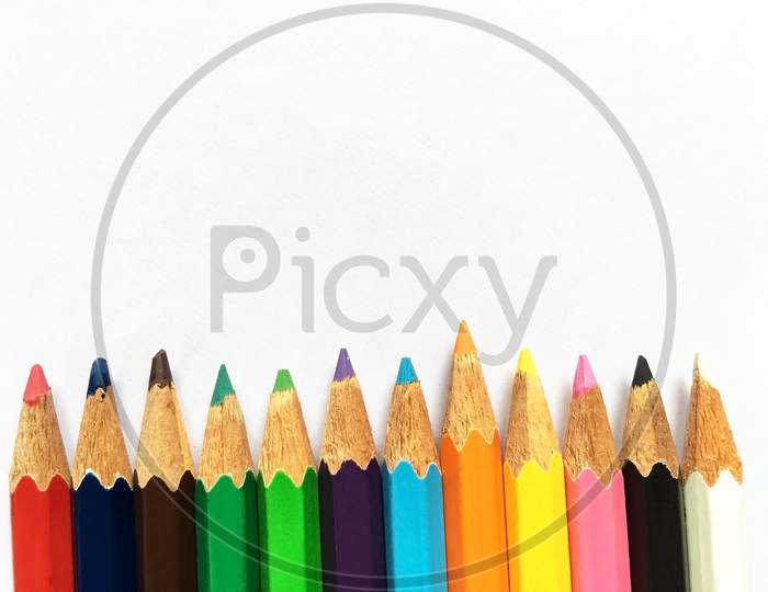 Row stacking colorful pencils isolated on white background