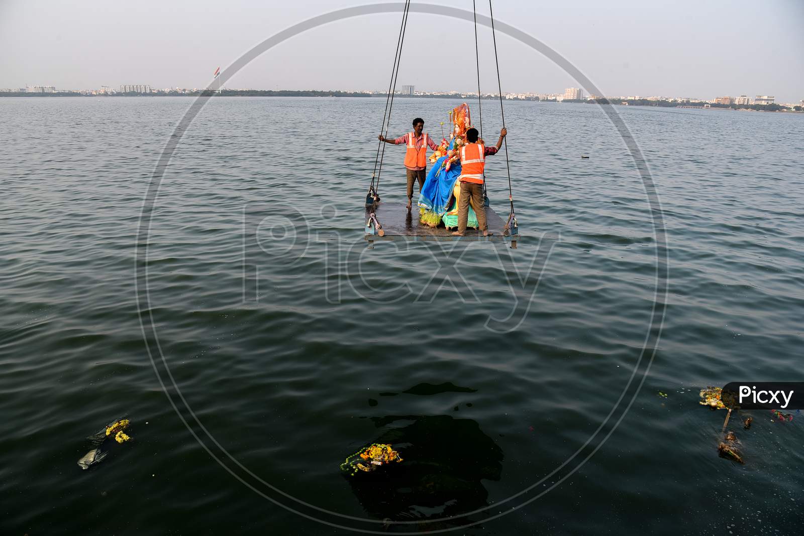 GHMC workers carry the Idols of Goddess Durga for immersion in Hussain Sagar on the last day of Navratri/Vijaya Dashami/Durga Puja in Hyderabad, October 26,2020.
