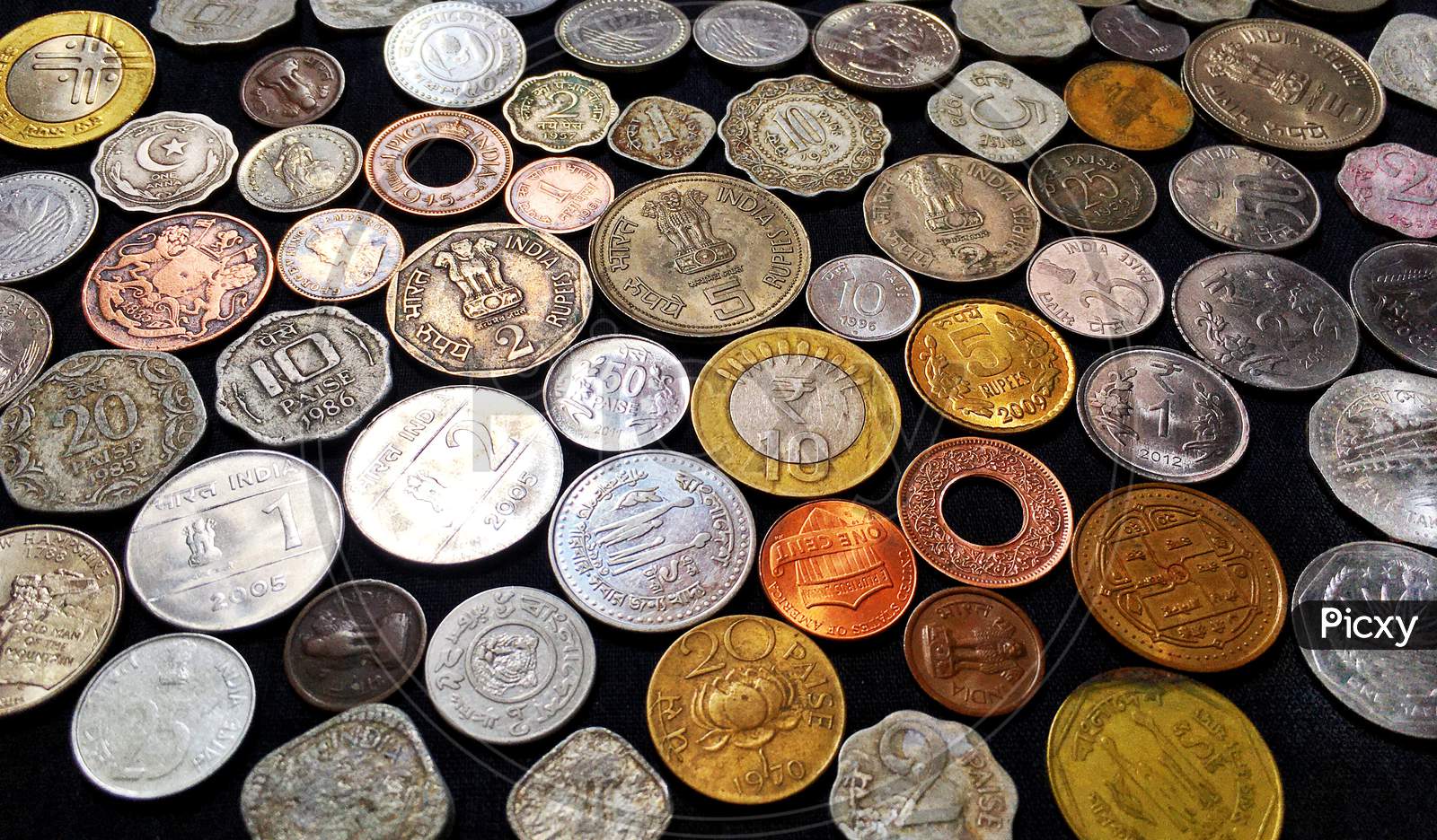 A collection of coins on black background