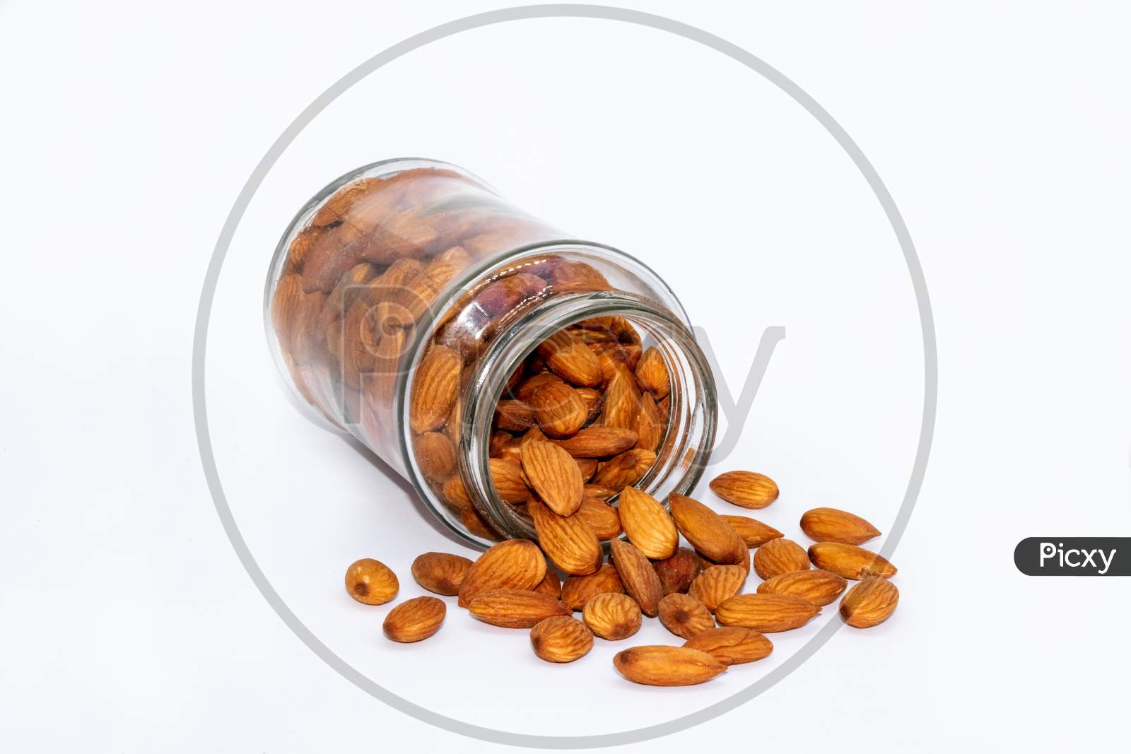 Almond nuts scatters from glass jar