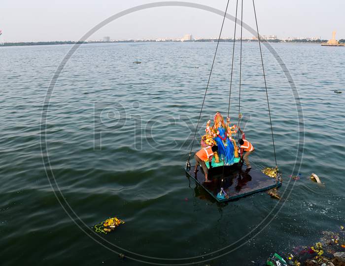 GHMC workers carry the Idols of Goddess Durga for immersion in Hussain Sagar on the last day of Navratri/Vijaya Dashami/Durga Puja in Hyderabad, October 26,2020.