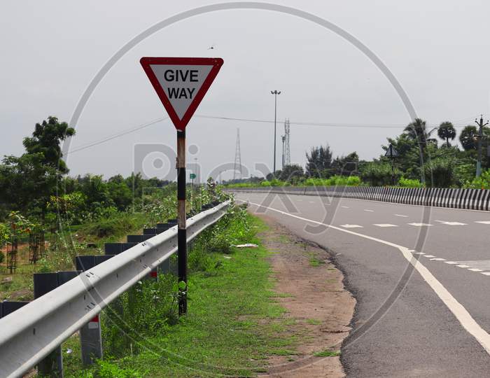 Give Way Sign On The Side Of National Highway Double Road